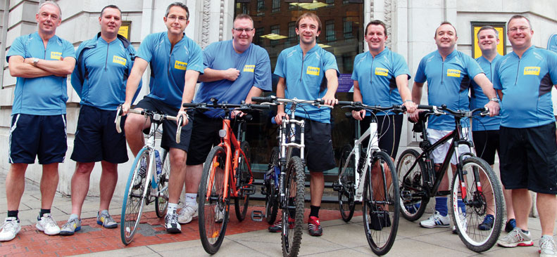 volunteers posing with bicycles