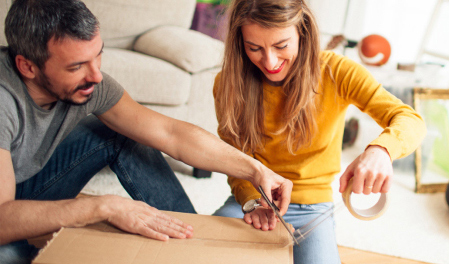 Couple packing a box together
